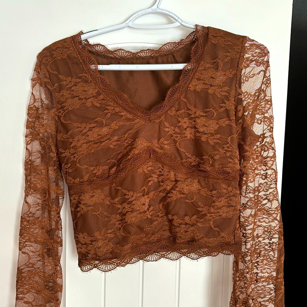 Brown long sleeved lace top. Never worn.